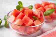 Crop shot of glass bowl with juicy and sweet watermelon cubes