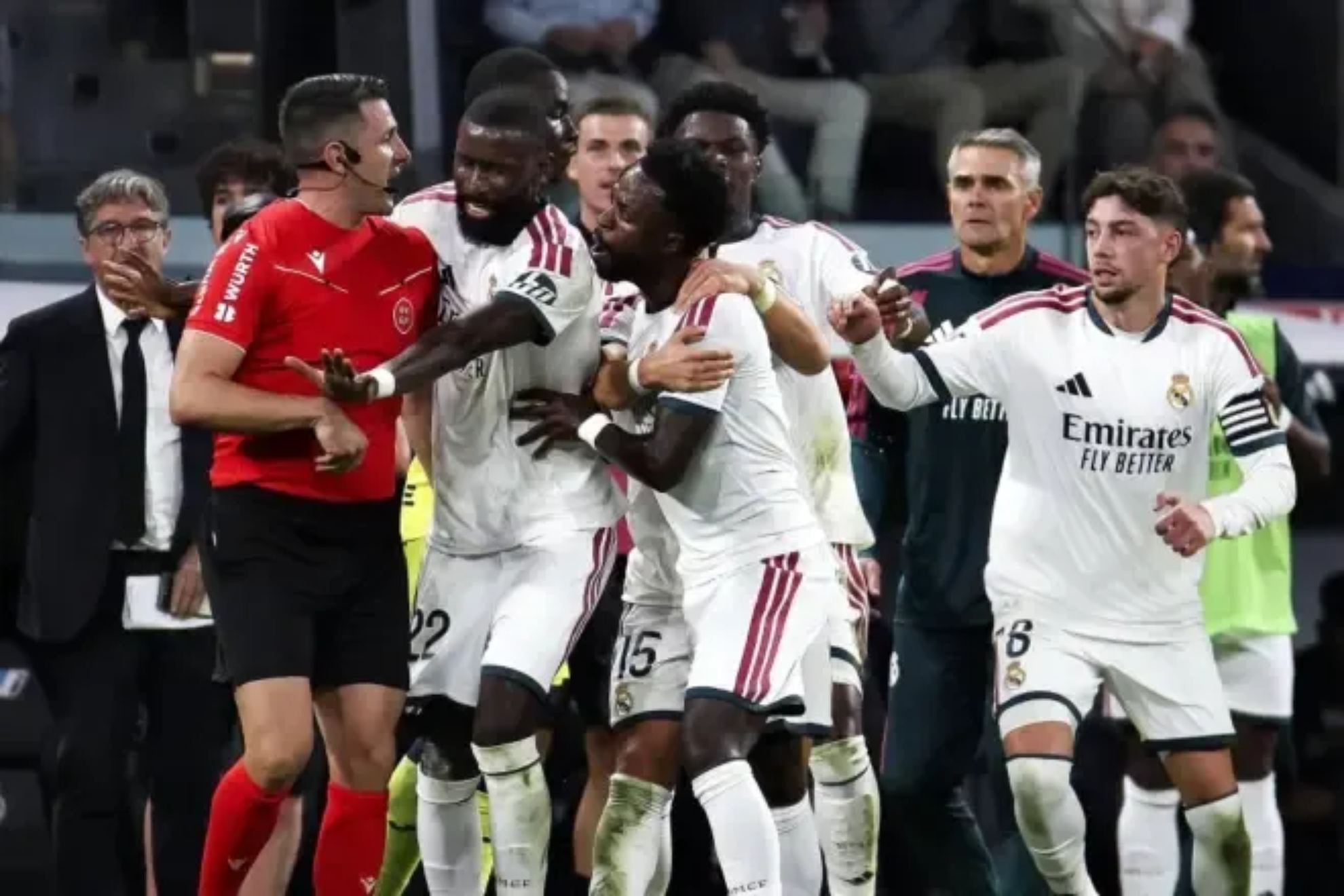 Vinicius is held back by his teammates after Diaz de Mera's red card