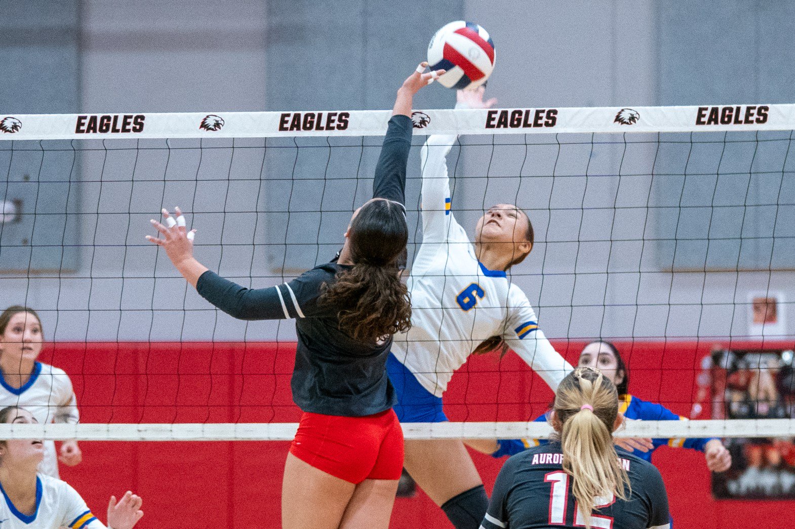 Aurora Central Catholic's Isabel Perez (6) plays the ball above the net against Aurora Christian's Mary Kendall during a nonconference match in Aurora on Thursday, Oct. 22, 2026. (Sean King / The Beacon-News)