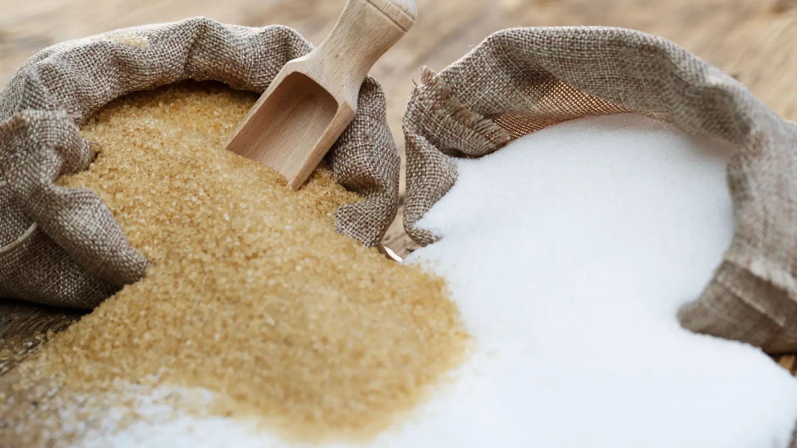 Two bags of sugar comparing the difference between brown sugar and white sugar.
