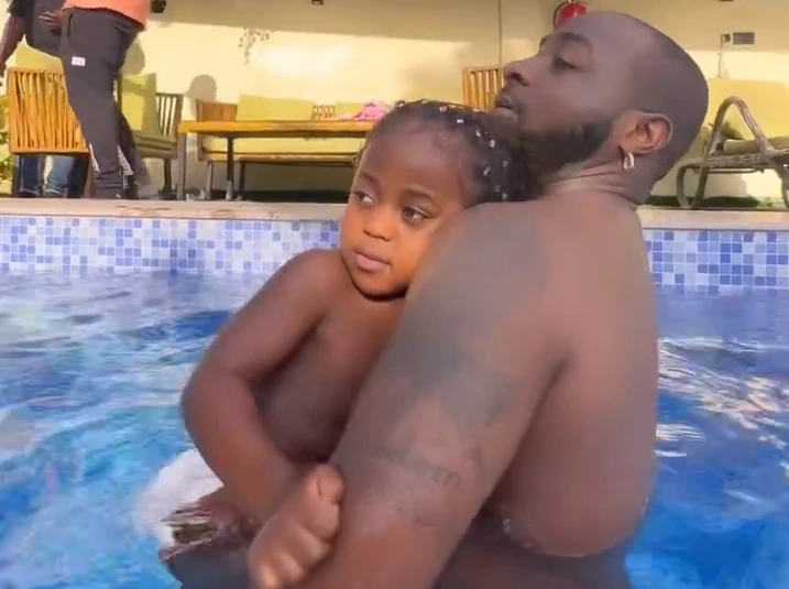 Singer, Davido And Son, Ifeanyi Adeleke Swim Together In A Swimming Pool