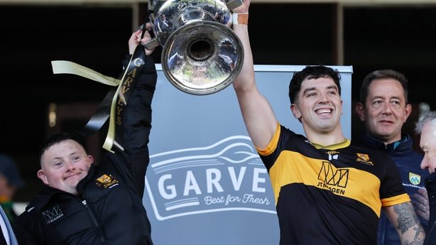 25 October 2026; Dr Crokes captain Tony Brosnan lifts the Bishop Moynihan cup alongside his brither Stephen after the Kerry County Senior Football Championship final match between Dr Crokes and Kenmare Shamrocks at Fitzgerald Stadium in Killarney, Kerry. Photo by Michael P Ryan/Sportsfile