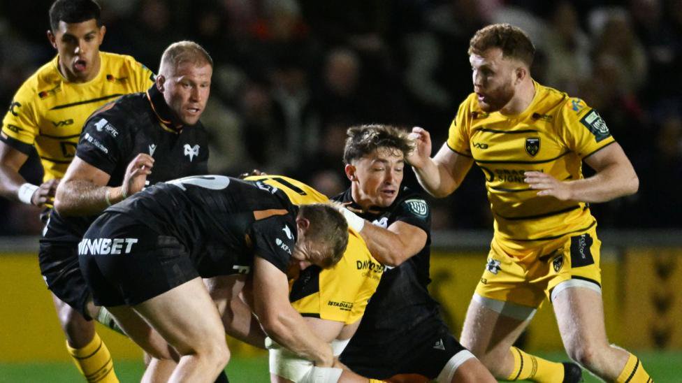 Dan Edwards makes a tackle for Ospreys against Dragons