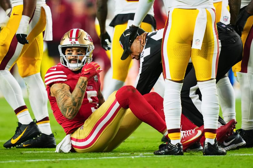 Mike Evans of the San Francisco 49ers sat on the ground after an injury against the Washington Commanders