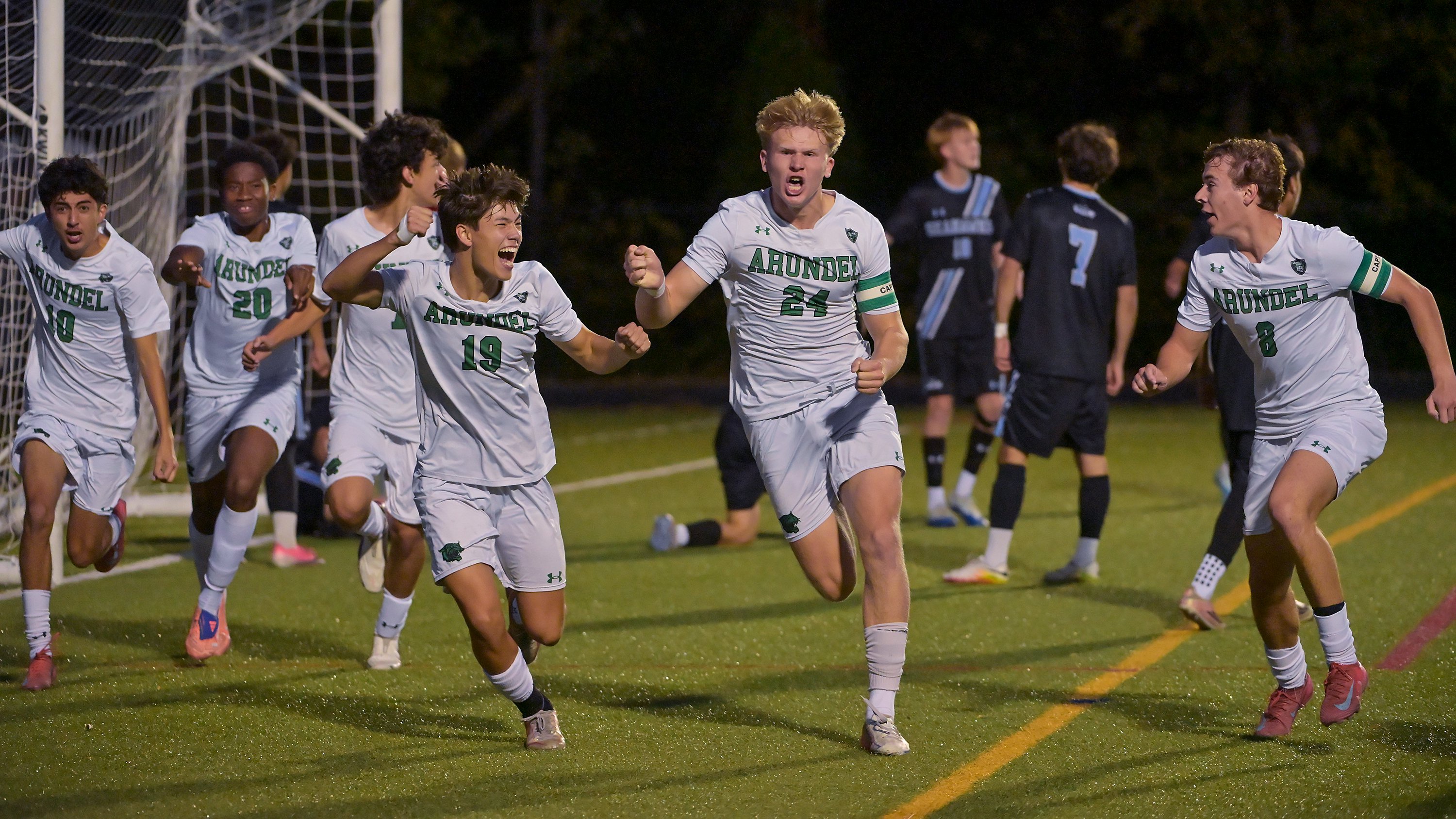 Arundel Wildcats Eli Johnstone-Clark #24 celebrates with teammates after scoring during the first half. The visiting Arundel Wildcats defeat the South River Seahawks, 2-1, in overtime in an MPSSAA Class 3A East II quarterfinal boys soccer game Wednesday evening. (Paul W. Gillespie/Staff)