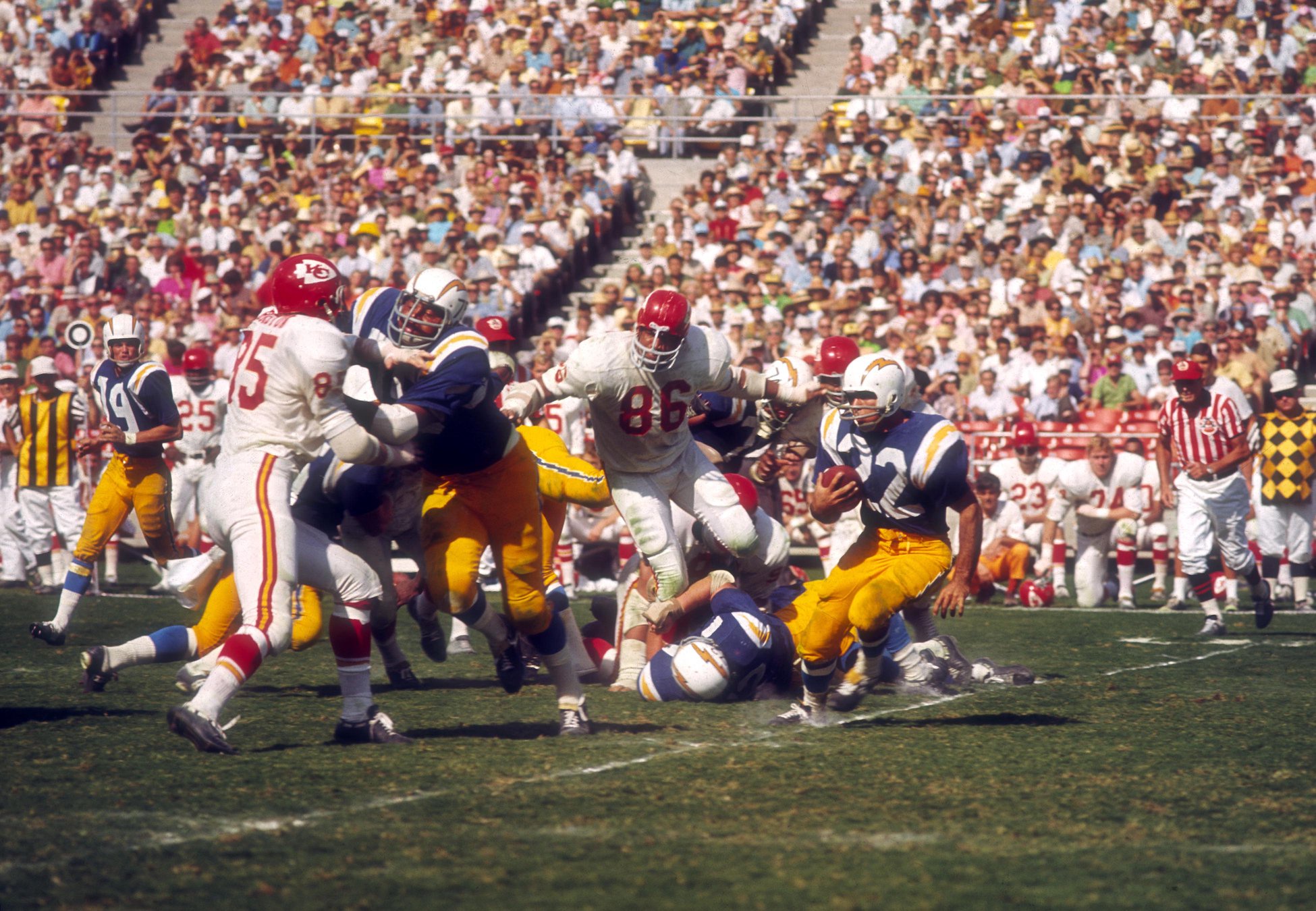 Unknown date; San Diego, CA, USA; FILE PHOTO;  San Diego Chargers running back Dickie Post (22) carries the ball as he is pursued by Kansas City Chiefs defensive end Buck Buchanan (86) at San Diego Stadium. Mandatory Credit: Darryl Norenberg-USA TODAY Sports