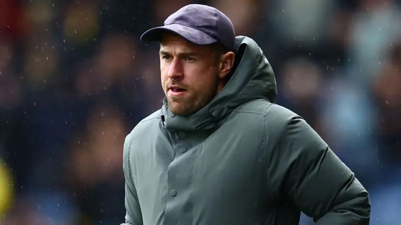 Aaron Ramsey wearing a purple baseball cat and green winter coat during Oxford United's game against Bradford City