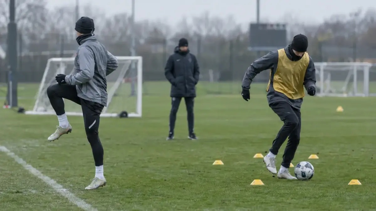 Anonymous footballers train separately at a professional club session before a match against Lazio.