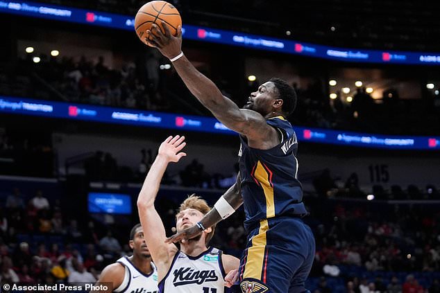 New Orleans Pelicans forward Zion Williamson (1) drives to the basket against Sacramento Kings forward Domantas Sabonis in the first half of an NBA basketball game, Thursday, Oct. 29, 2026, in New Orleans. (AP Photo/Gerald Herbert)
