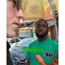 "Why are you cameraing? You need to pay" Agbero asks as he attempts to extort British tourist in Lagos market (video)