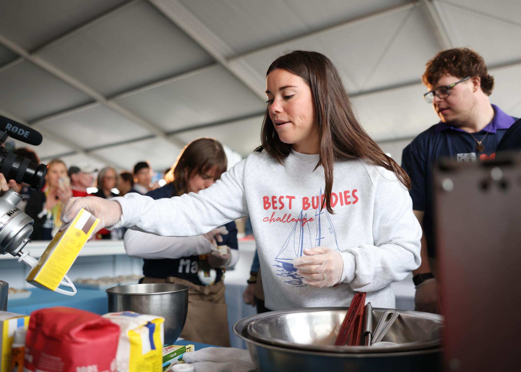 Participants volunteer at a cooking station during the Best Buddies Challenge.