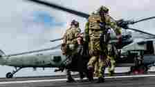 Explosive Ordnance Disposal Technicians, assigned to Explosive Ordnance Disposal Mobile Unit 1, board an MH-60S Seahawk on the flight deck of George Washington while underway in the Pacific Ocean, June 26, 2024.