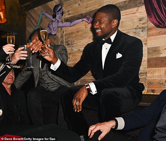 Usher looked suave in a classic black tuxedo as he raised a glass to celebrate his show's selling out at the iconic O2