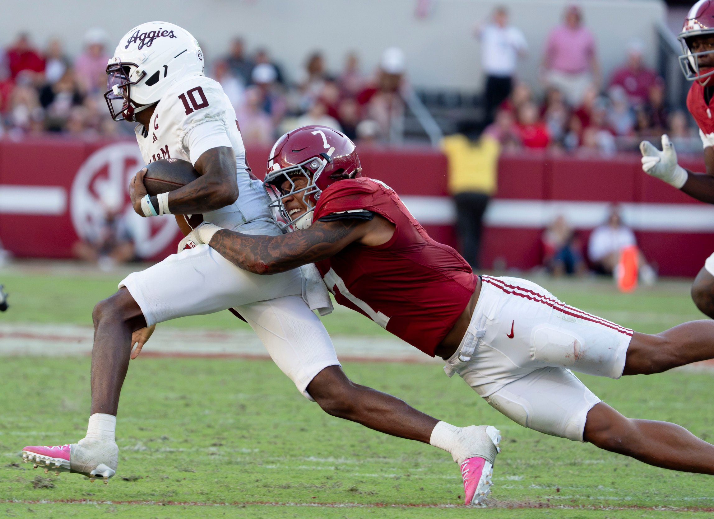 Oct 24, 2026; Tuscaloosa, AL, USA; Texas A&amp;M quarterback Marcel Reed (10) is tackled behind the line of scrimmage on a running play by Alabama linebacker Caleb Woodson (7) at Saban Field at Bryant Denny Stadium. 