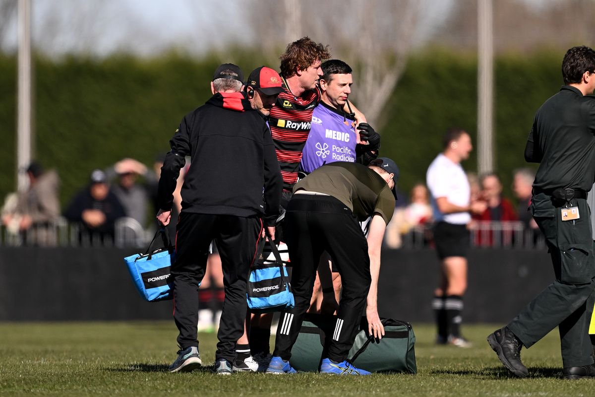 Cullen Grace of Canterbury is assisted from the field after sustaining