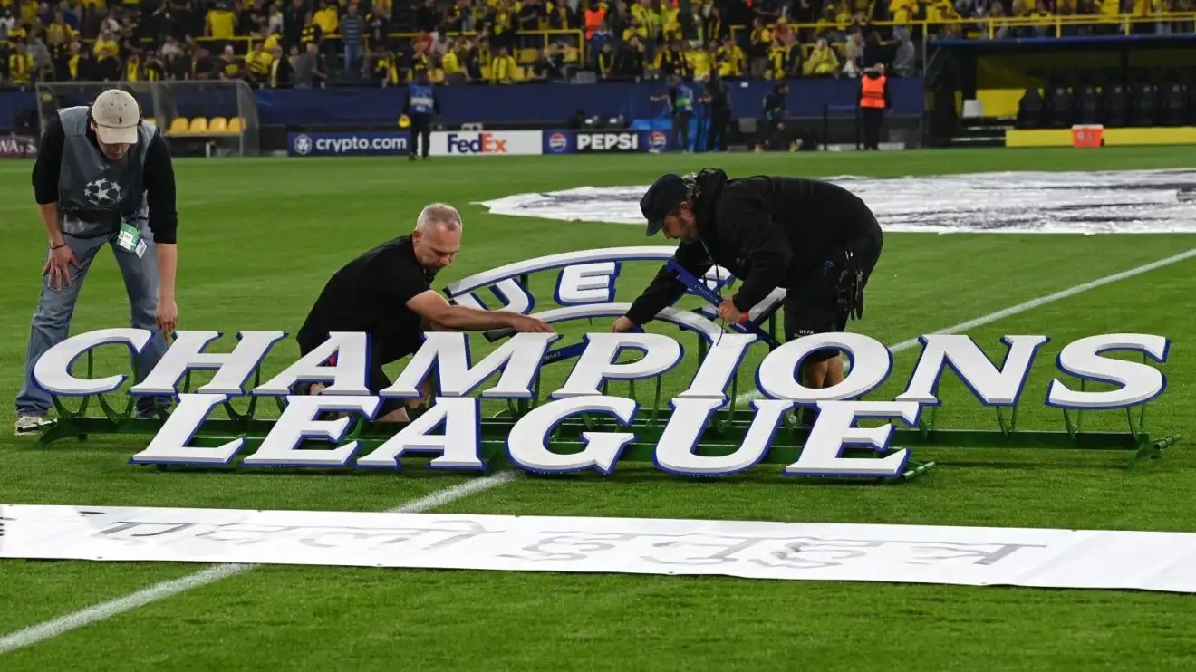 Helpers put up a Champions League sign