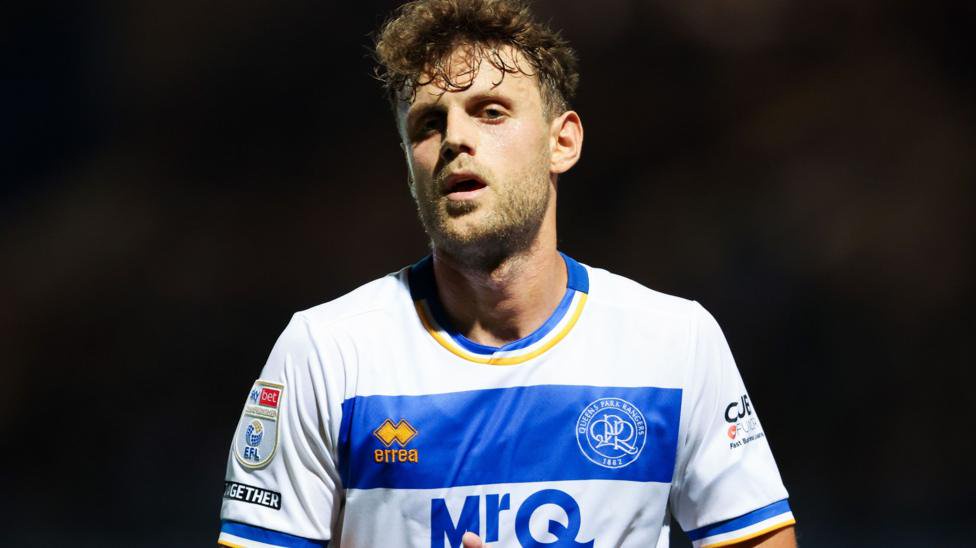 Nicolas Madsen in blue and white hooped QPR shirt