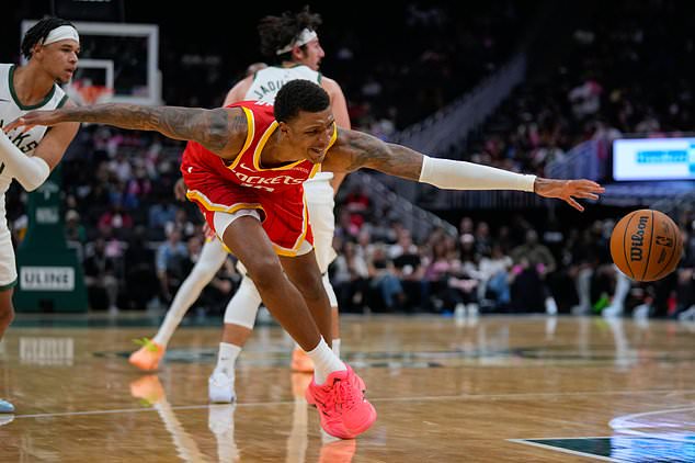 Houston Rockets forward Jabari Smith Jr. reaches for a loose ball during the first half of an NBA basketball game against the Milwaukee Bucks Wednesday, Oct. 28, 2026, in Milwaukee. (AP Photo/Kayla Wolf)
