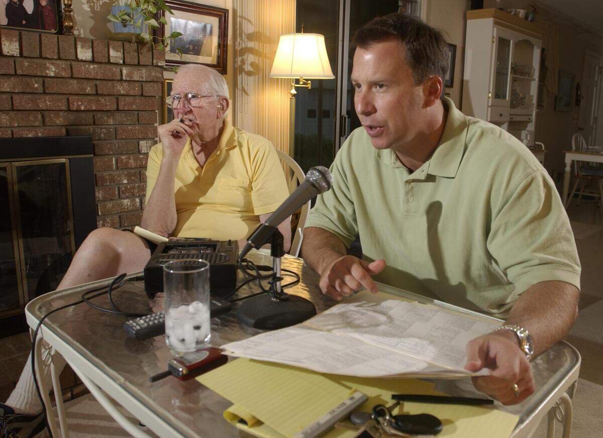 Todd Ellis, right, calls a game at home under the watchful eye of Bob Fulton in 2003.