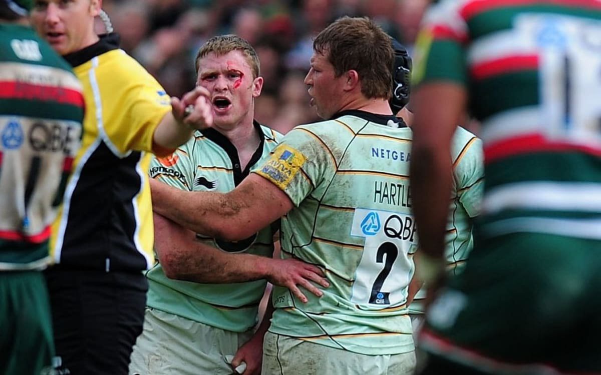 Saints wing Chris Ashton (c) is held back by captain Dylan Hartley
