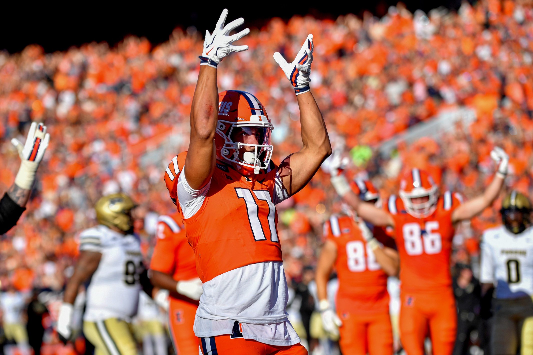 Illinois Fighting Illini wide receiver Collin Dixon (17) signals his touchdown during the first half against the Purdue Boilermakers at Gies Memorial Stadium.