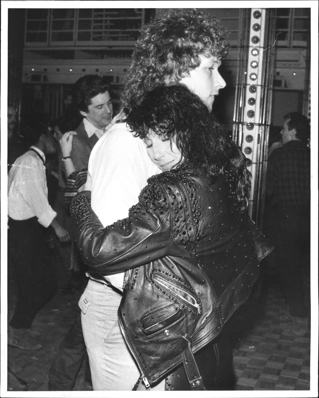 Cher and hockey player Ron Duguay embrace on the dance floor at Studio 54.