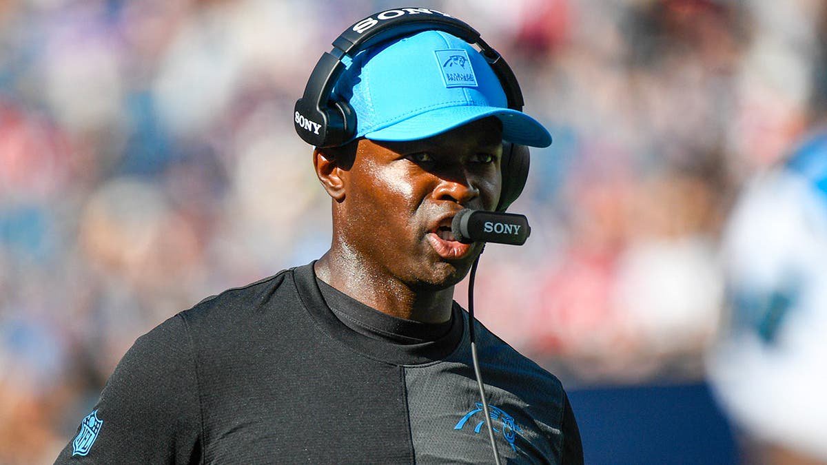 Ejiro Evero, Carolina Panthers defensive coordinator, looks on during an NFL game.
