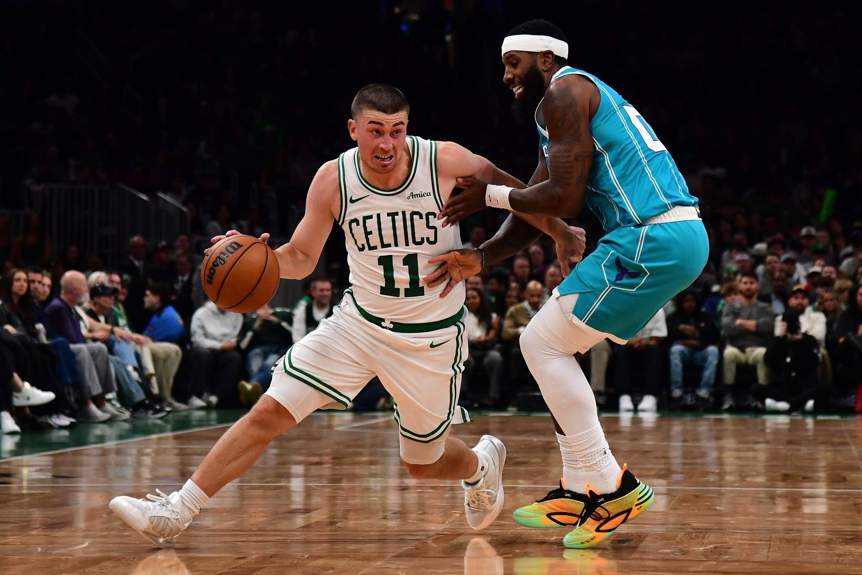 Oct 14, 2026; Boston, Massachusetts, USA;  Boston Celtics guard Payton Pritchard (11) controls the ball while Charlotte Hornets forward Royce O'Neale (00) defends during the first half at TD Garden. Mandatory Credit: Bob DeChiara-Imagn Images