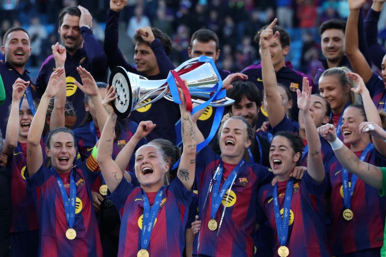 Barcelona's Claudia Pina lifts the trophy as she celebrates winning the UEFA Women's Champions League with her teammates