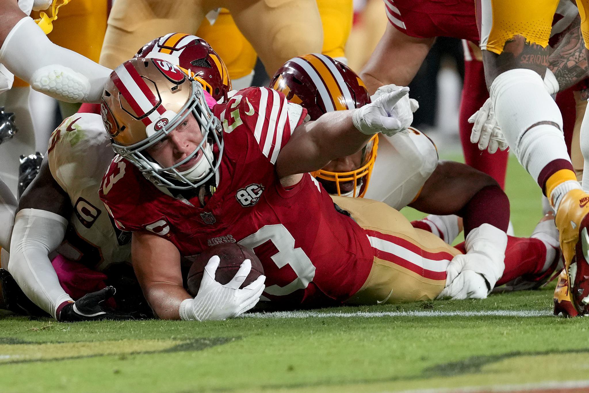 Christian McCaffrey of the San Francisco 49ers celebrates after scoring a touchdown against the Washington Commanders.