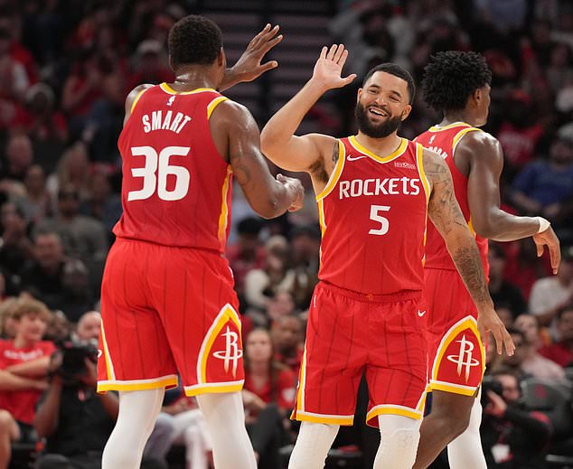 Houston Rockets guards Fred VanVleet (5) and Marcus Smart (36) celebrate the Rockets' lead against the Dallas Mavericks during the first half of an NBA basketball game, Wednesday, Oct. 21, 2026, in Houston. (AP Photo/Karen Warren)