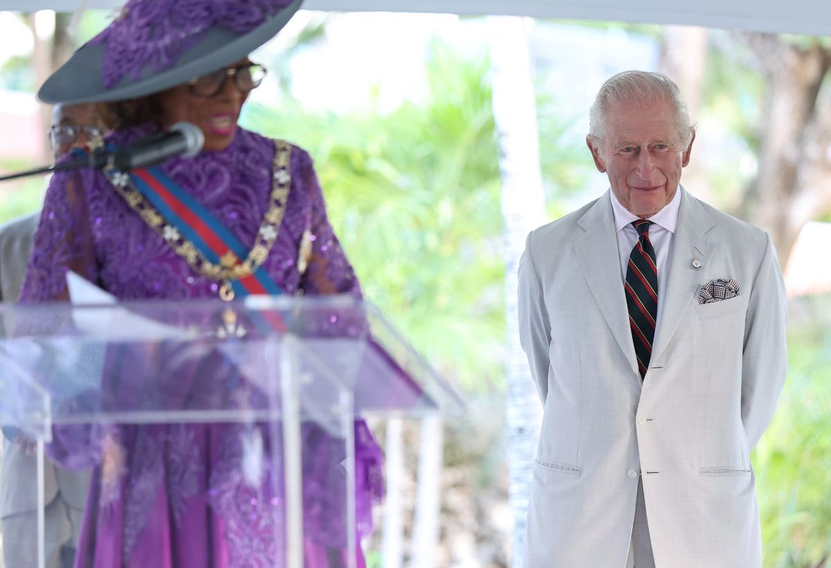 Our monarch smiles as he listens to the welcome speech by Governor-General, Dame Cynthia Pratt