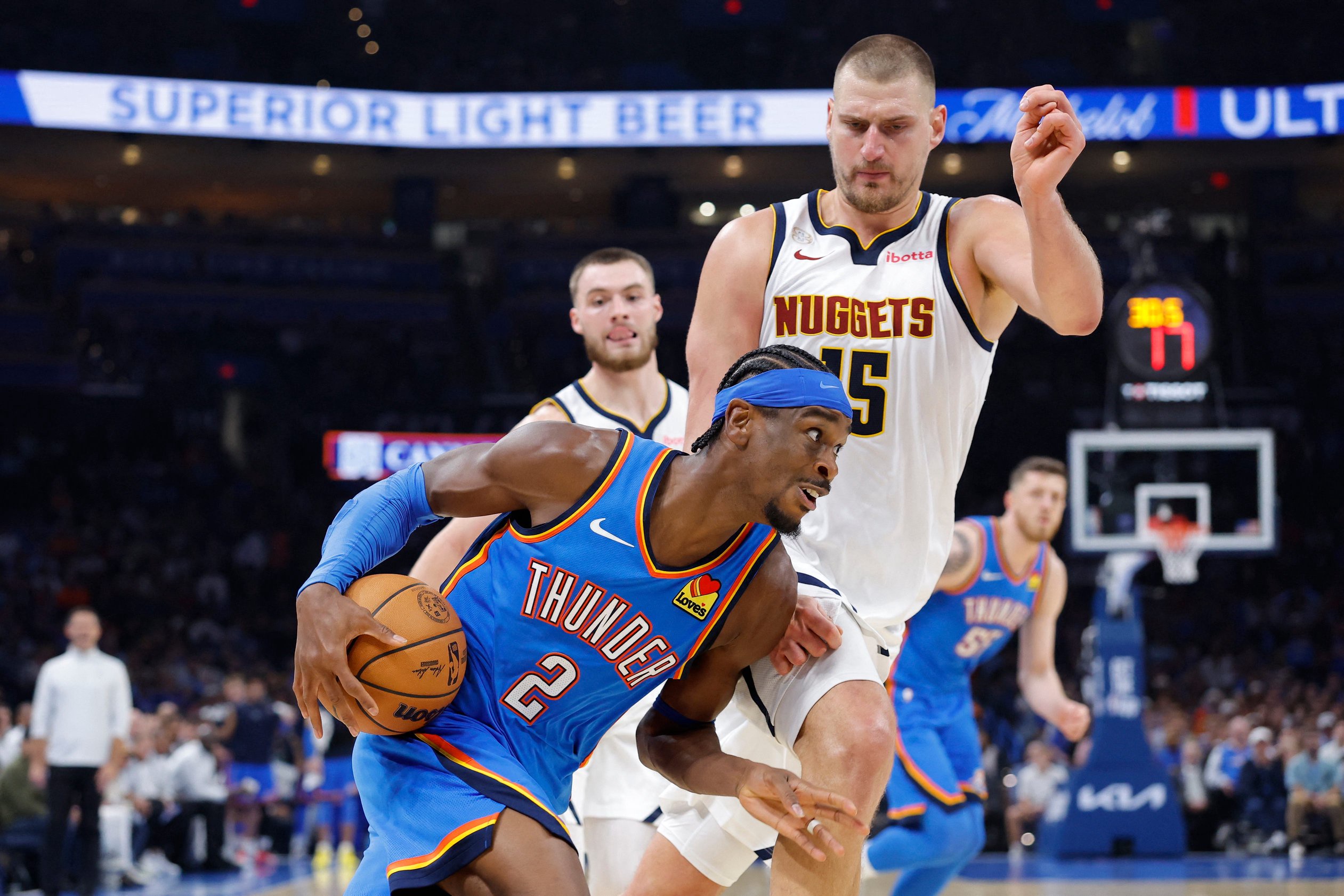Oct 22, 2026; Oklahoma City, Oklahoma, USA; Oklahoma City Thunder guard Shai Gilgeous-Alexander (2) moves around Denver Nuggets center Nikola Jokic (15) during the first half at Paycom Center. Mandatory Credit: Alonzo Adams-Imagn Images
