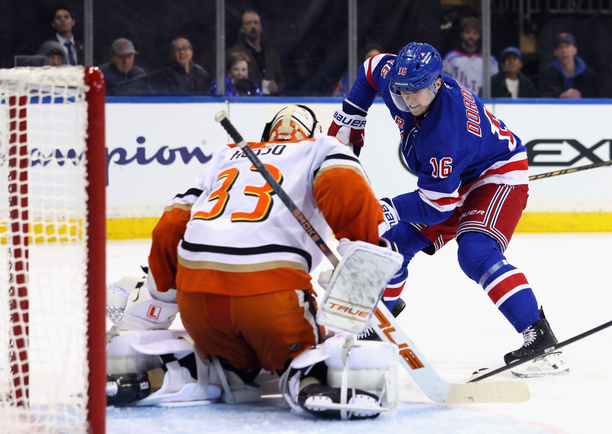 Anaheim Ducks goalie Ville Husso stops New York Rangers' Pavel Dorofeyev during an NHL game.