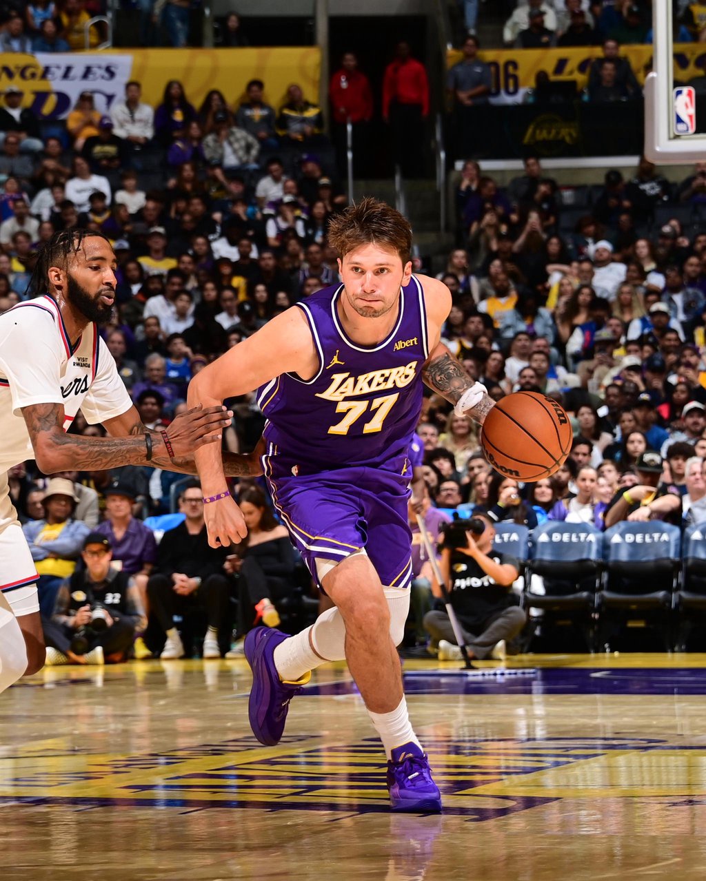 Luka Doncic #77 of the Los Angeles Lakers dribbles the ball during the game against the LA Clippers.