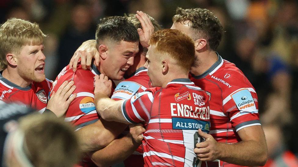 Freddie Thomas is congratulated by Gloucester team-mates after scoring a try against Bath