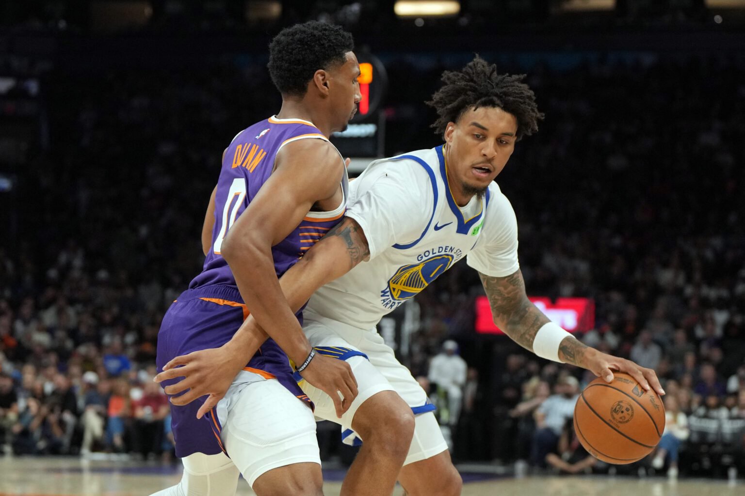 Oct 24, 2026; Phoenix, Arizona, USA; Golden State Warriors forward Yaxel Lendeborg (1) shields the ball from Phoenix Suns forward Ryan Dunn (0) in the first half at Mortgage Matchup Center. Mandatory Credit: Rick Scuteri-Imagn Images