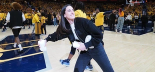WNBA star Caitlin Clark autographs ultrasound photo during appearance at Pacers playoff game