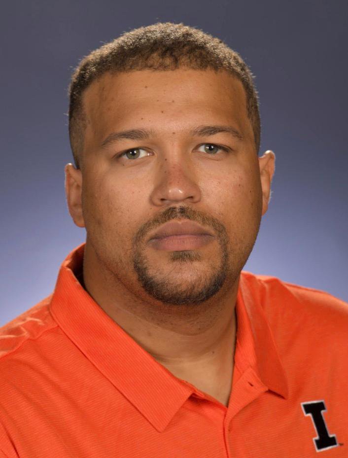 Miles Smith wearing an orange polo shirt.