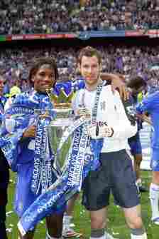 Cech and Drogba holding the Premier League trophy
