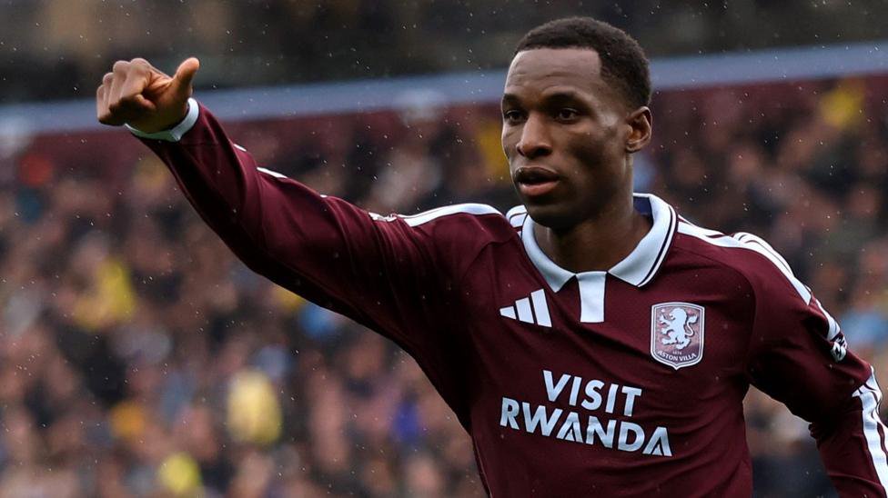 Nicolas Jackson, wearing a claret and blue shirt, celebrates a goal for Aston Villa against Manchester City