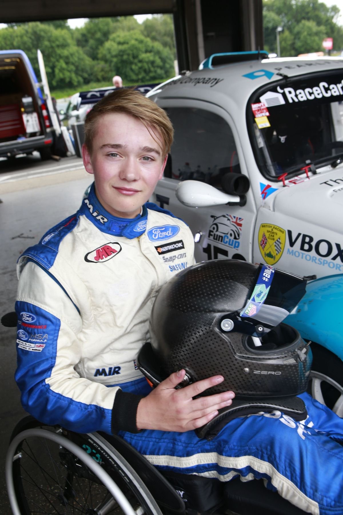 Billy Monger holding a crash helmet