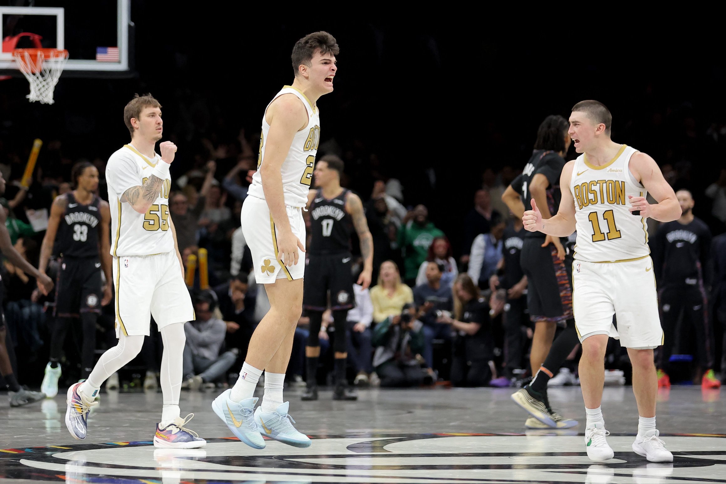 Jan 23, 2026; Brooklyn, New York, USA; Boston Celtics guard Hugo Gonzalez (28) celebrates his three point shot against the Brooklyn Nets with guards Baylor Scheierman (55) and Payton Pritchard (11) during the first overtime at Barclays Center. Mandatory Credit: Brad Penner-Imagn Images