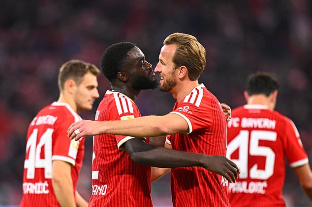 Munich's Dayot Upamecano and teammate Harry Kane after scoring a goal during the German Bundesliga soccer match between FC Bayern Munich and Borussia Dortmund in Munich, Germany, Saturday, Oct. 31, 2026. (Tom Weller//dpa via AP)