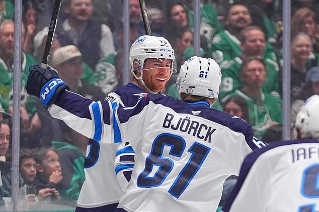 Winnipeg Jets center Gabriel Vilardi, left, celebrates after scoring with teammate center Viggo Bjorck (61) during the second period of an NHL hockey game against the Dallas Stars, Thursday, Oct. 22, 2026, in Dallas. (AP Photo/LM Otero)