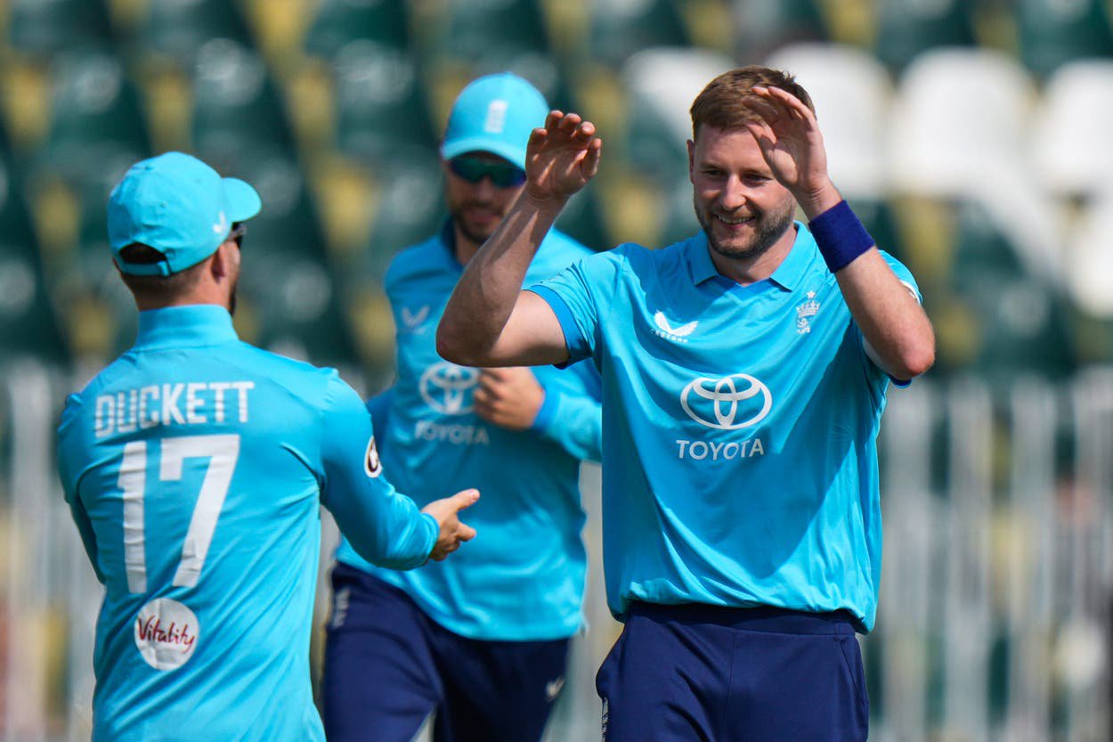 Gus Atkinson celebrates with team-mates after taking the wicket of Pakistan’s Fakhar Zaman (Anjum Naveed/AP)