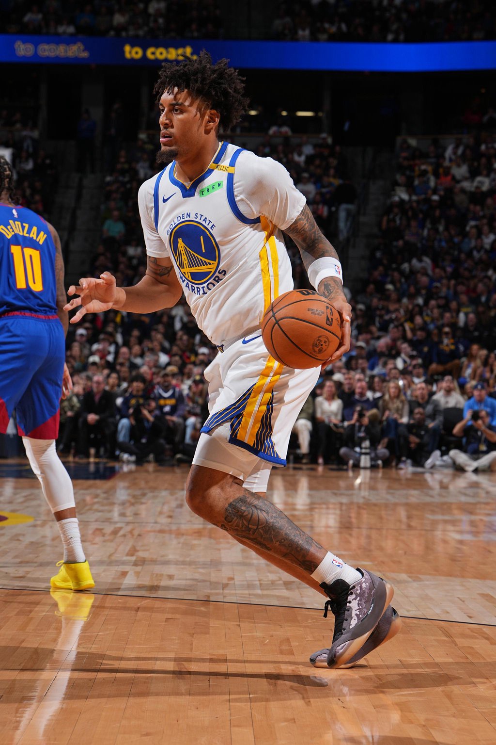 Golden State Warriors' Yaxel Lendeborg dribbles the ball during a game against the Denver Nuggets.