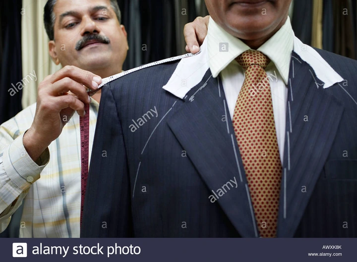 Tailor measuring business man with tape measure, close up Stock Photo -  Alamy