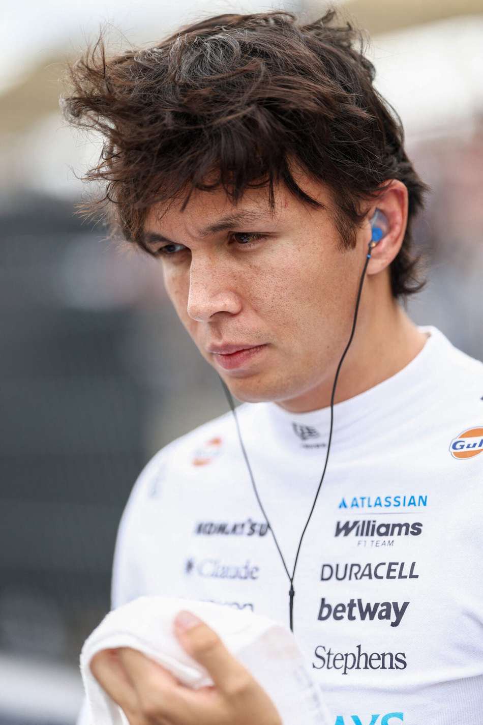 Piloto da Williams F1 Team no GP dos EUA de F1, com fones de ouvido e toalha na mão.