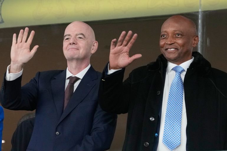 CAF President Patrice Motsepe and FIFA President Gianni Infantino wave from the tribune during the 2025 Africa Cup of Nations